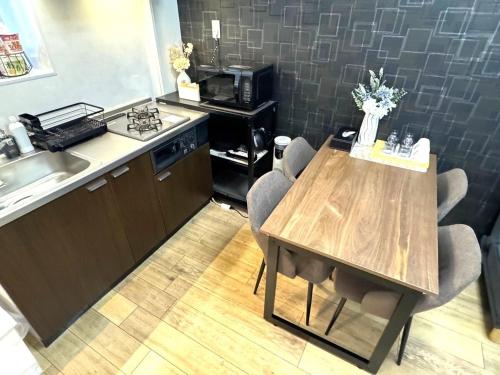 a kitchen with a wooden table and a counter top at K2 square 502 in Nagoya