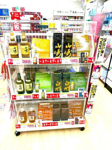 a grocery store aisle with a cart of food at K2 square 502 in Nagoya