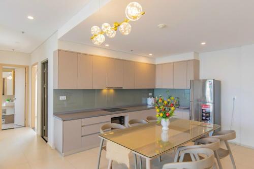 a kitchen with a table with flowers on it at The Sóng Vũng Tàu Hideaway in Vung Tau