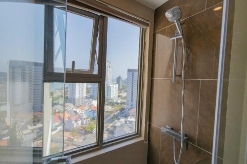 a shower stall in a bathroom with a window at The Sóng Vũng Tàu Hideaway in Vung Tau