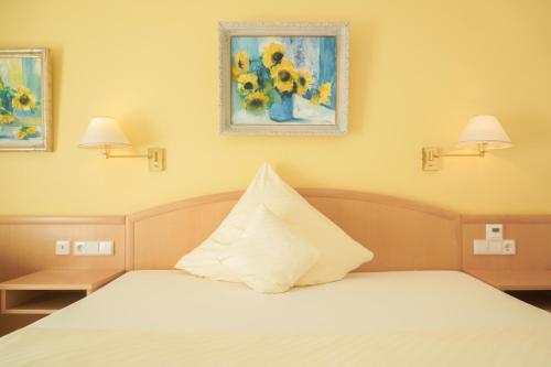 a bedroom with a bed with a pillow on it at Hotel Garni in der Breite in Albstadt