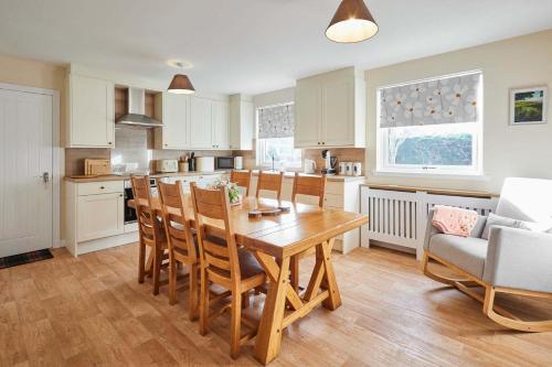 a kitchen with a wooden table and chairs at Host & Stay - Audrey's Cottage in Kirk Yetholm