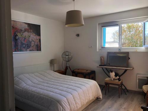 une chambre avec un lit, un bureau et une télévision dans l'établissement Appartement sur la colline avec accès piscine, à Volx