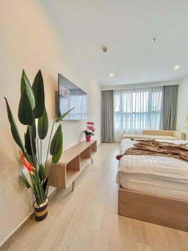 a bedroom with a bed and a potted plant at The Sóng Vũng Tàu Hideaway in Vung Tau