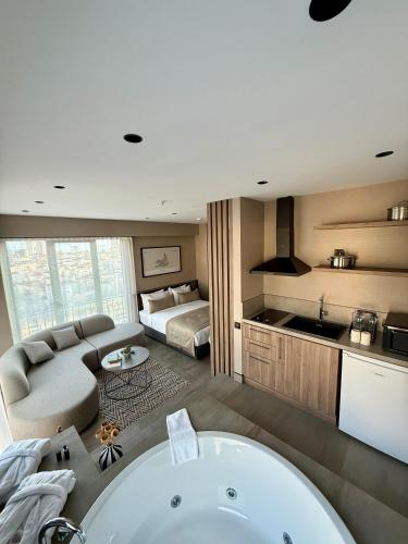a bathroom with a bath tub and a bedroom at Cityloft 147 in Istanbul