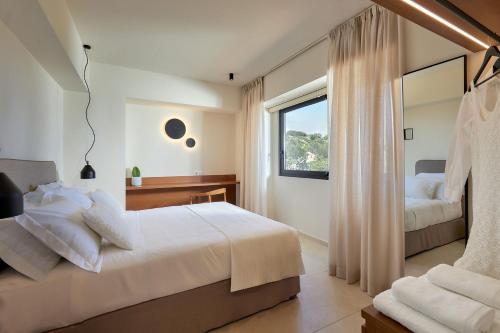 a bedroom with two beds and a window at The NooK -Luxury living at the edge of tranquility in Heraklion