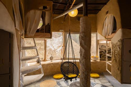 a room with a hammock in a tiny house at Paarli Dhara capsules in Bīr