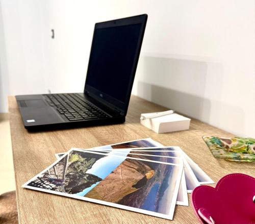 a magazine sitting on a table next to a laptop at MIRO'S Casa Vacanze Pompei in Pompei
