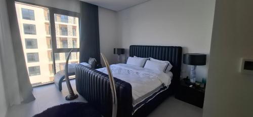 a bedroom with a bed and a large window at almoaj ,juman 2 marina view,level3 in Muscat