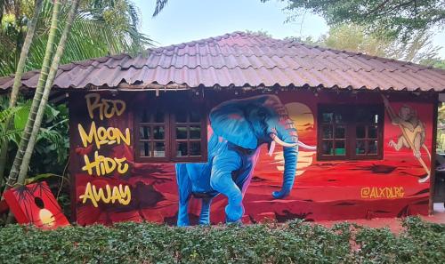 a mural of an elephant in front of a house at Red Moon Hideaway in Ko Chang