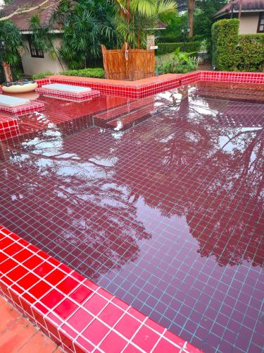 a swimming pool covered in red and blue tiles at Red Moon Hideaway in Ko Chang