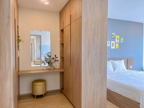 a small bedroom with a bed and a mirror at The Sóng Vũng Tàu Hideaway in Vung Tau