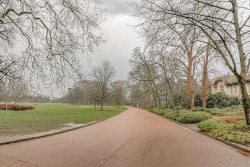 an empty road in a park with trees at Suite Premium proche Tête d'Or in Lyon