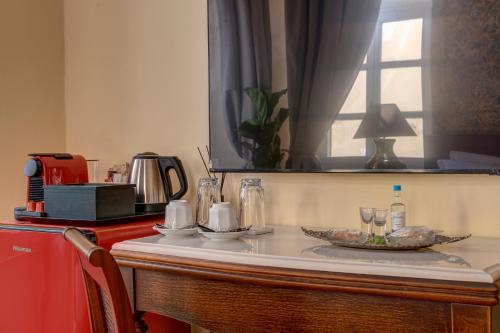 a counter with a table with plates and glasses on it at Palazzo Santa Maria - Historic Hotels of Europe in Ermoupoli