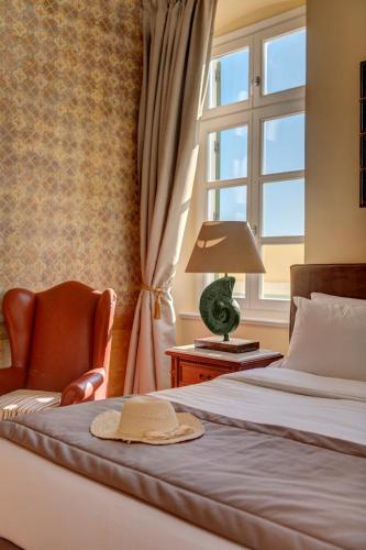 a bedroom with two beds and a window at Palazzo Santa Maria - Historic Hotels of Europe in Ermoupoli