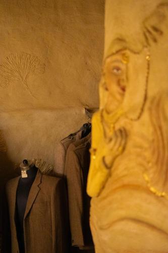 a man talking on a cell phone next to a pile of clothes at Paarli Dhara,Bir in Bīr