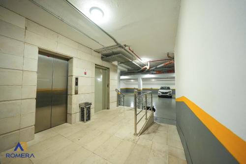 an empty room with a hallway with a parking garage at Romera Hotel in Jeddah