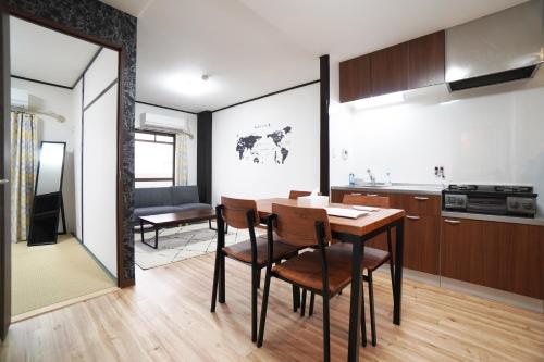 a kitchen and dining room with a table and chairs at Charade Kyobashi in Osaka