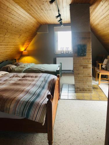 a bedroom with two beds and a brick pillar at Dalhausen, Am Schönste Aussicht in Beverungen