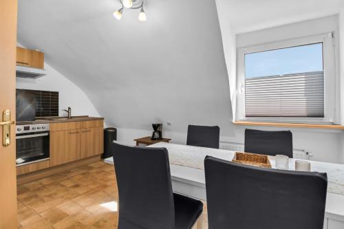 a kitchen with a table and chairs and a window at 24-7 Living - Unna Central City Apartments in Unna