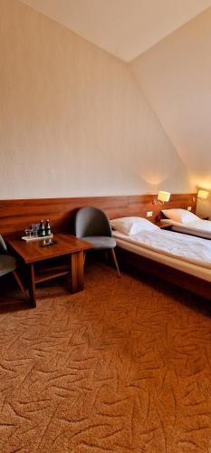 a bedroom with a large bed and a table at Szafranowy Dwór in Strawczyn