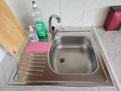 a sink in a kitchen with a faucet at Hero Avenue Apartment in Narva