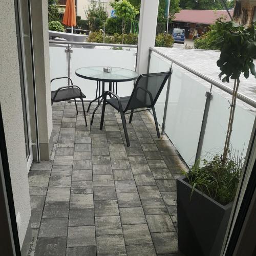 a patio with a table and chairs on a balcony at Franzl Hof Zorell in Ravensburg