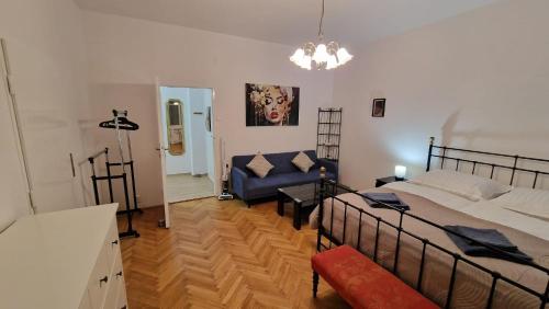 a bedroom with a bed and a couch in it at Apartment Justina in Staré Mesto