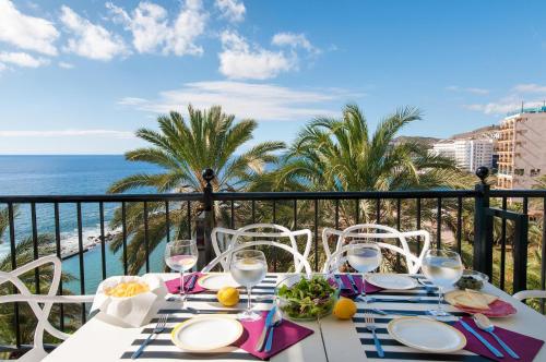 a table with a view of the ocean on a balcony at Beach and View Arguineguin MG by VillaGranCanaria in Arguineguín