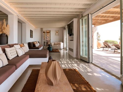 a living room with a couch and a table at Mykonos Rocks Villas & Suites in Mýkonos City
