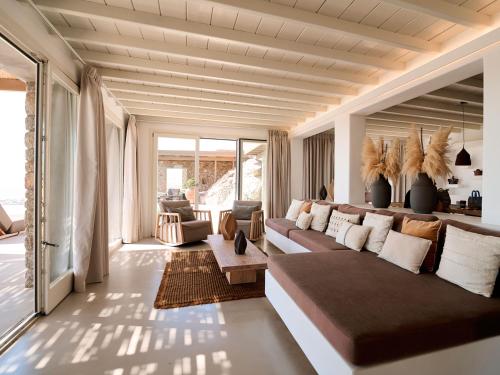 a large living room with a couch and a table at Mykonos Rocks Villas & Suites in Mýkonos City