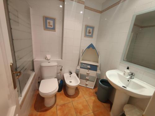 a bathroom with a toilet and a sink at La casa del verano in Isla Cristina