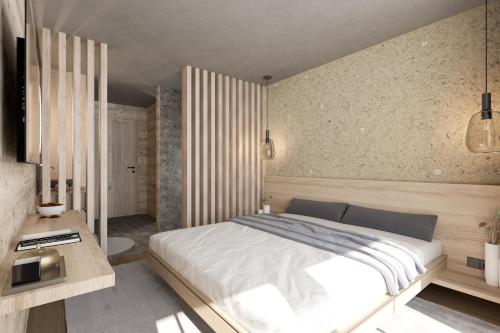 a bedroom with a large bed and a desk at Berghotel Wald & Wiesn in Balderschwang