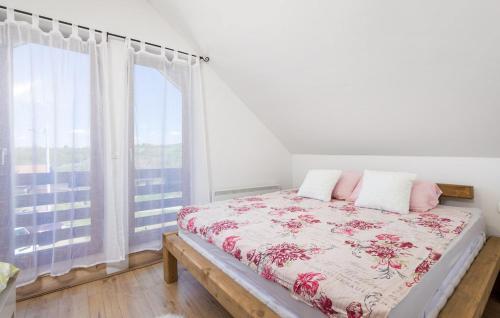 a bedroom with a bed and a large window at Vacation home Elizabeta in Slunj
