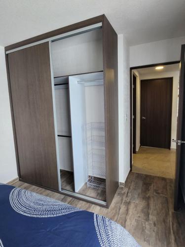 a large mirror in a bedroom with a closet at Residencial Eduardo Molina in Mexico City