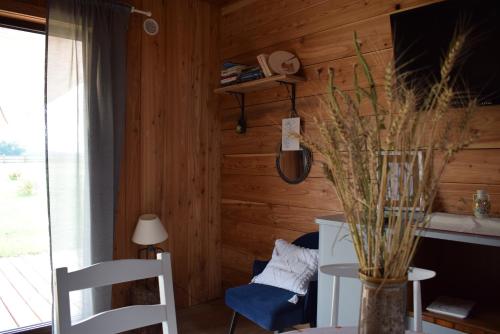 a room with wooden walls and a table and chairs at Leśny Zakątek Uroczysko -Apartamenty Nowoczesnej Stodoły in Stogniewice