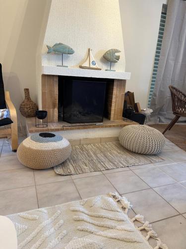 a living room with a fireplace and a couch at Bella Elena 1 in Nea Makri