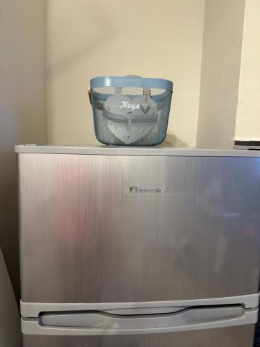 a blue bucket sitting on top of a refrigerator at Bella Elena 1 in Nea Makri