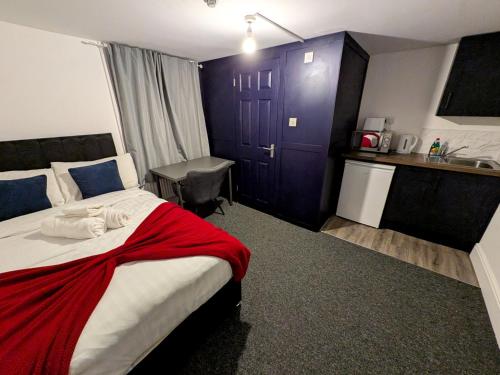 a hotel room with a bed and a sink at Comfortable Stay - NG7 in Nottingham