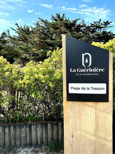 a sign in front of a fence in front of a house at Lovely fully renovated beach villa in La Guérinière