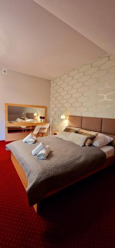 a bedroom with a large bed in a room at Szafranowy Dwór in Strawczyn