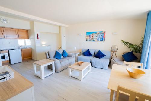 a living room with a couch and a table at Luz Beach Apartments in Luz