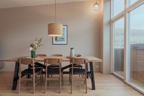 a dining room with a table and chairs at By The Sea - Boathouse with Hot Tub & Parking in Vestmanna