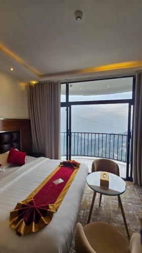 a hotel room with a bed and a large window at فندق فيفاء الفاخر in Fayfāʼ