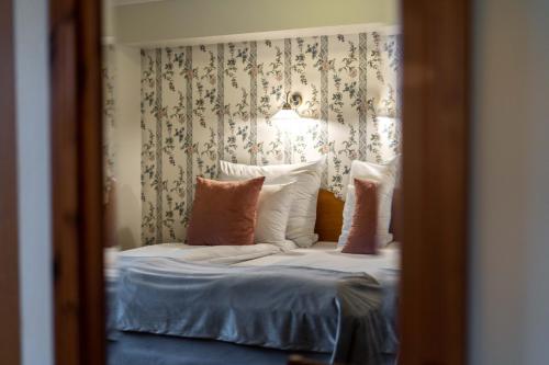 a reflection of a bed in a mirror at Kronen Gaard Hotel in Sandnes