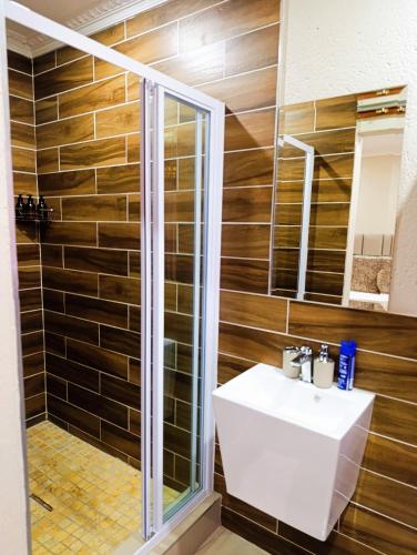 a bathroom with a sink and a shower at Elephant Villa Private Room in Nelspruit