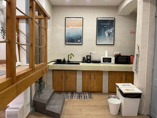 a kitchen with a sink and a microwave at LOFT Studio in Central Lisbon in Lisbon