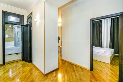 a room with a hallway with a bed and a mirror at Apartment BİCOCCA in Baku