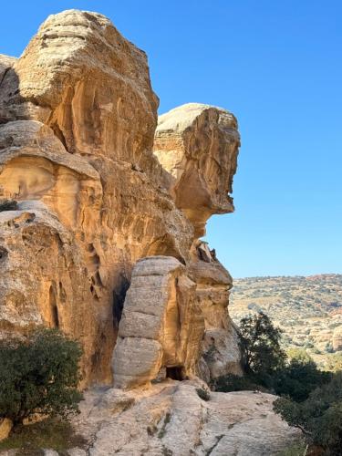 a rock cliff with a cave in it at Dana Trail Hotel in Dana