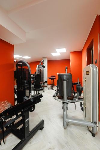 a gym with several chairs and orange walls at Villa Olivieri B&B Wellness House in Viterbo